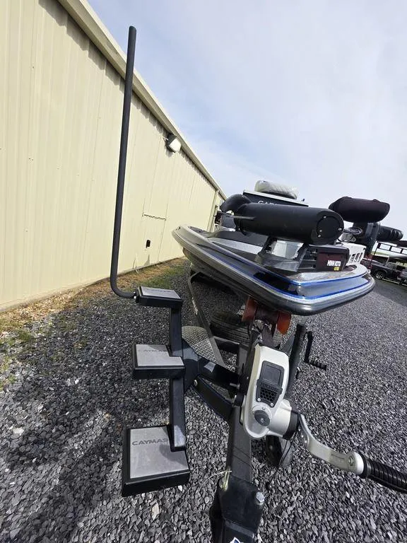 Slide: The Image of 2021 Caymas CX 21 boat trailer with steps, parked on gravel near a building. - 20