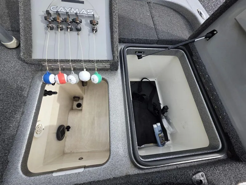Slide: The Image of 2021 Caymas CX 21 boat storage compartments with organized fishing gear and accessories. - 30