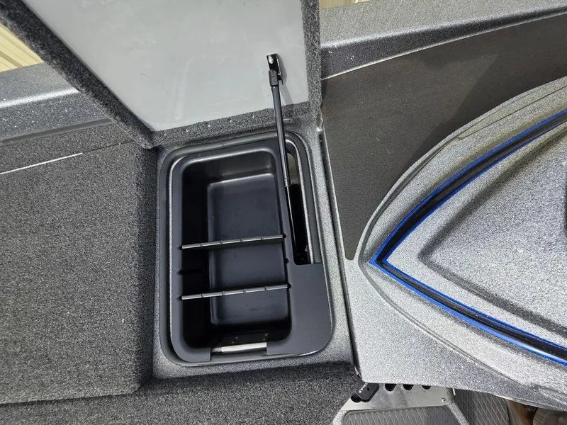 Slide: The Image of 2021 Caymas CX 21 boat storage compartment with open lid and organized interior. - 36
