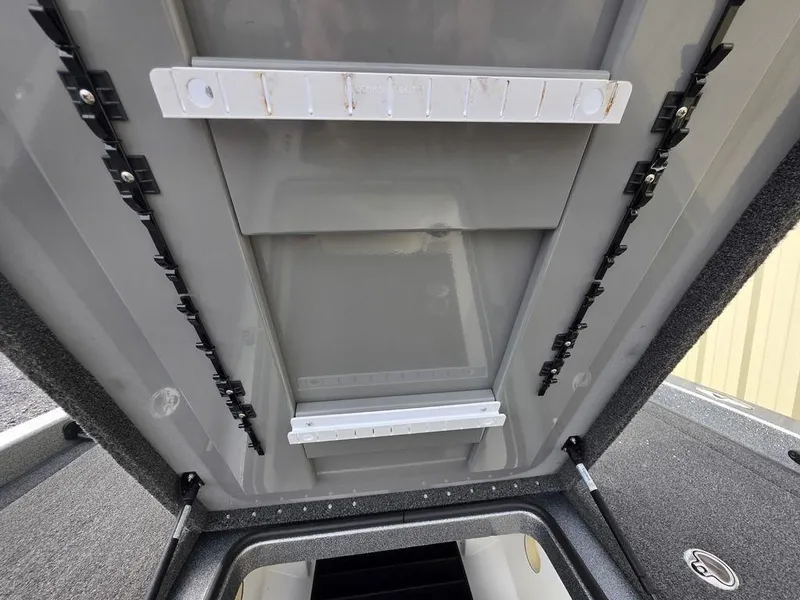 Slide: The Image of 2021 Caymas CX 21 boat storage compartment with organized interior layout. - 39