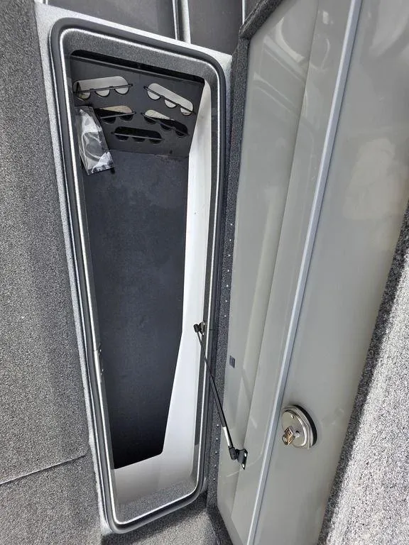 Slide: The Image of 2021 Caymas CX 21 boat storage compartment with secure lock and organized interior. - 41