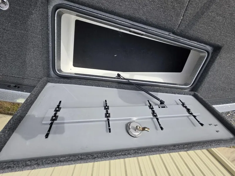 Slide: The Image of Open storage compartment in 2021 Caymas CX 21 boat, featuring organized interior layout. - 42
