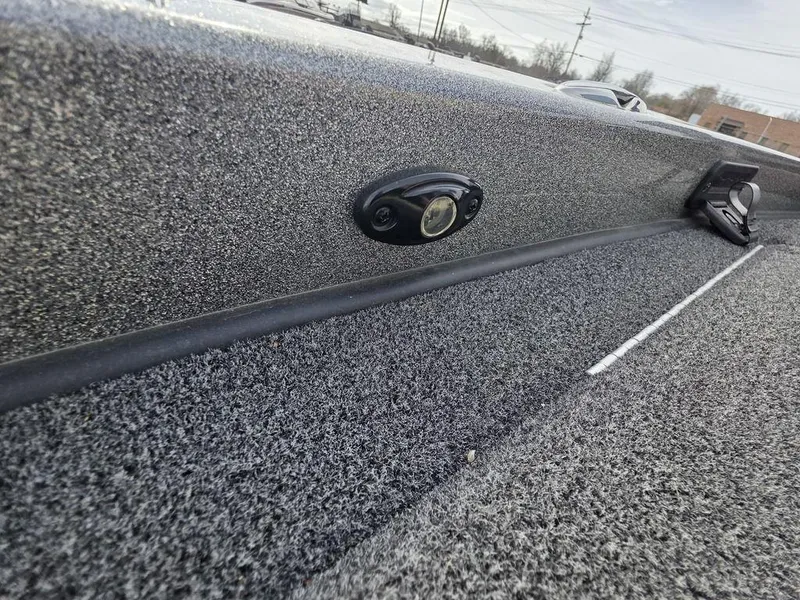 Slide: The Image of 2021 Caymas CX 21 boat interior detail with textured surface and mounted accessory. - 46