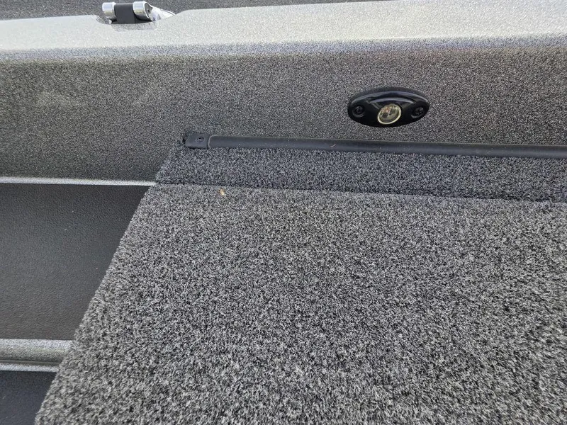 Slide: The Image of 2021 Caymas CX 21 boat interior with gray carpet and storage compartment. - 47