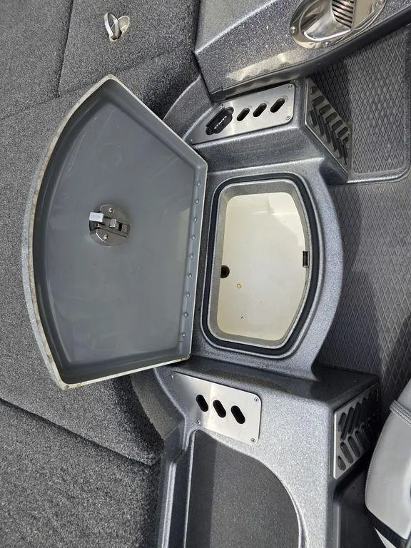 Slide: The Image of 2021 Caymas CX 21 boat storage compartment with open lid, showcasing interior space. - 48