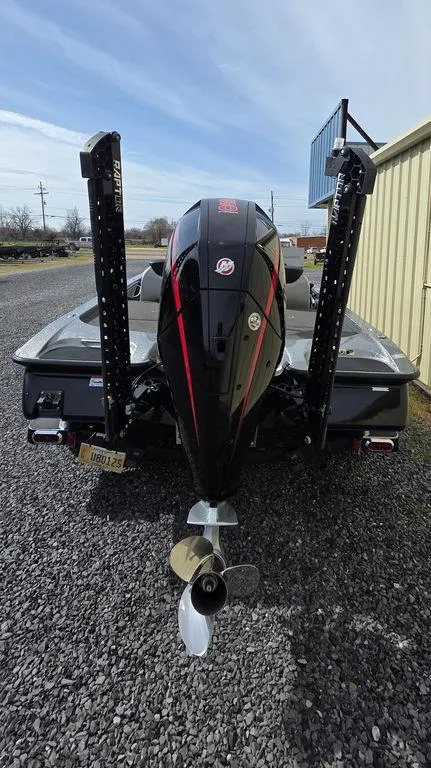 Slide: The Image of 2021 Caymas CX 21 boat rear view with powerful outboard motor on gravel surface. - 5