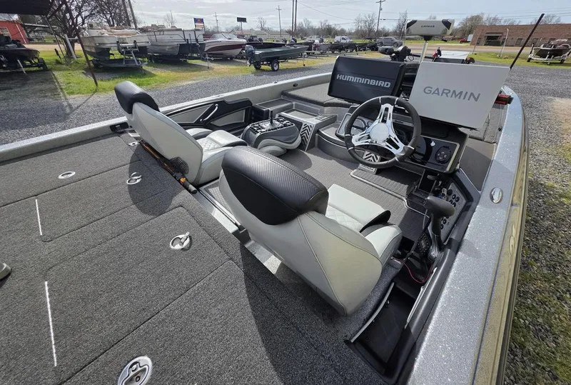 Slide: The Image of 2021 Caymas CX 21 boat interior with steering wheel, seats, and navigation equipment. - 7