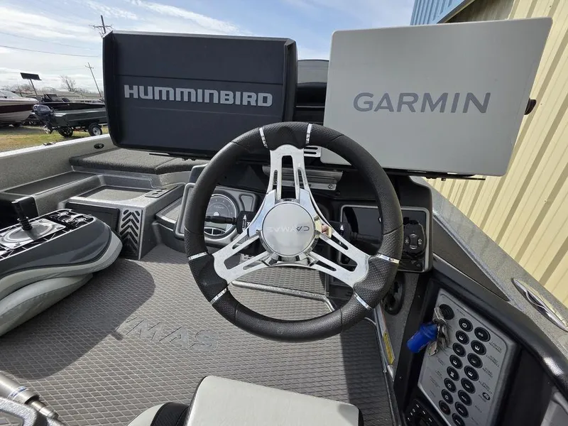 Slide: The Image of 2021 Caymas CX 21 boat dashboard with Humminbird and Garmin displays. - 8