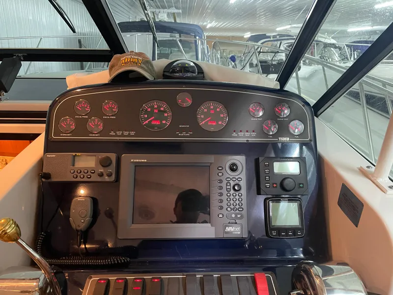 Slide: The Image of Control panel of a 2002 Tiara Yachts 3500 Open, featuring navigation and communication equipment. - 13