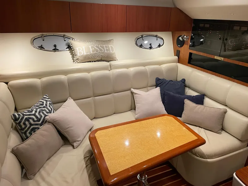 Slide: The Image of Luxurious interior of 2002 Tiara Yachts 3500 Open with plush seating and decorative pillows. - 18