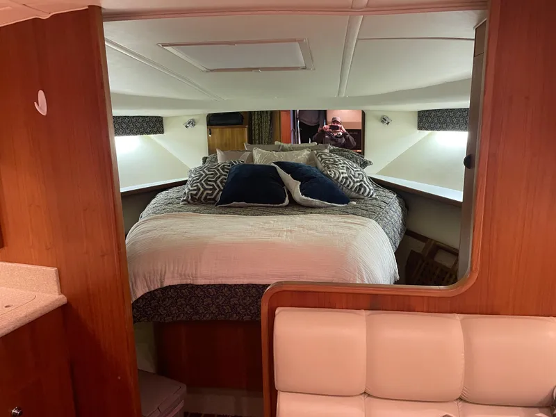 Slide: The Image of Luxurious cabin interior of 2002 Tiara Yachts 3500 Open with cozy bedding. - 20