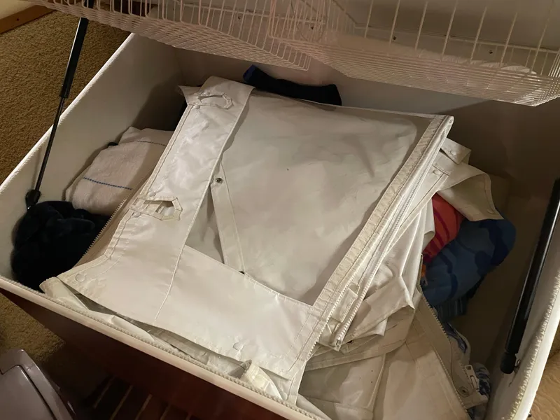 Slide: The Image of Storage compartment on a 2002 Tiara Yachts 3500 Open, containing folded canvas and towels. - 22