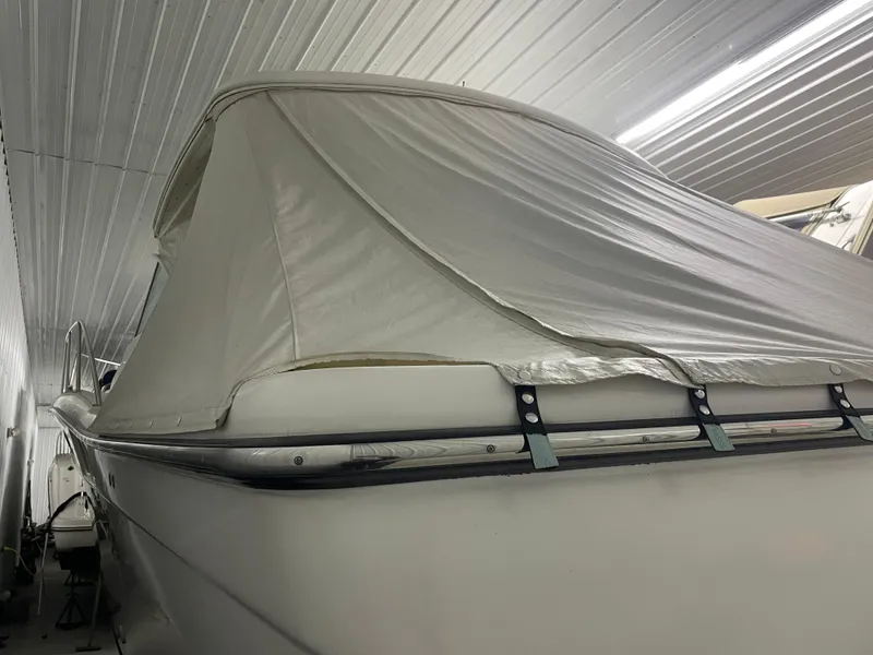 Slide: The Image of 2002 Tiara Yachts 3500 Open covered in storage, side view. - 3