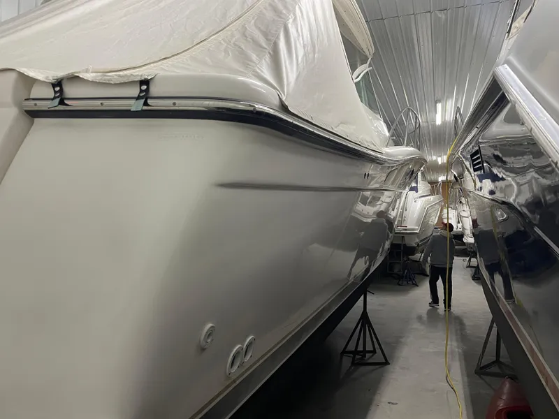 Slide: The Image of 2002 Tiara Yachts 3500 Open stored indoors, covered, alongside other boats. - 32