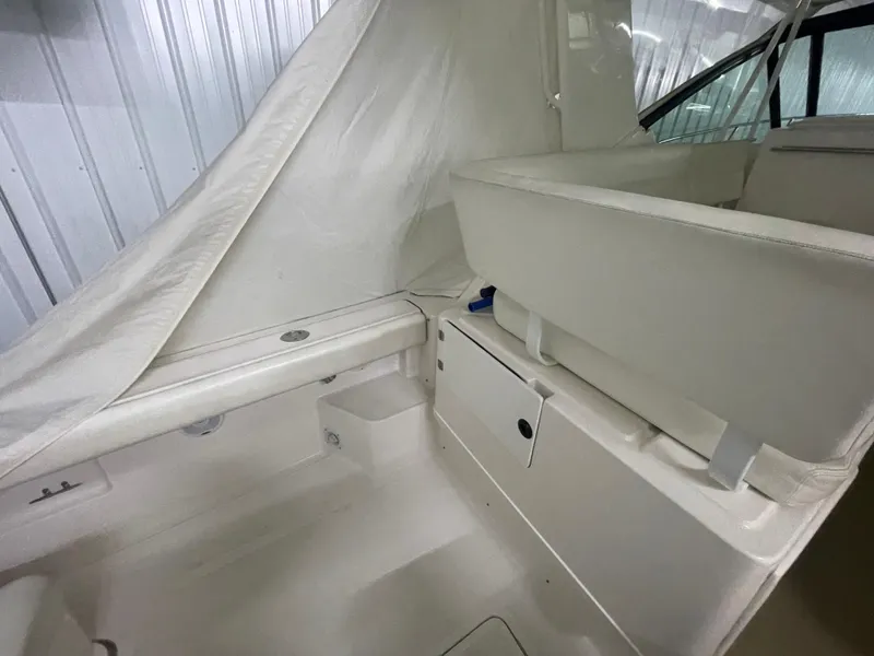 Slide: The Image of 2002 Tiara Yachts 3500 Open interior with white seating and storage compartments. - 4