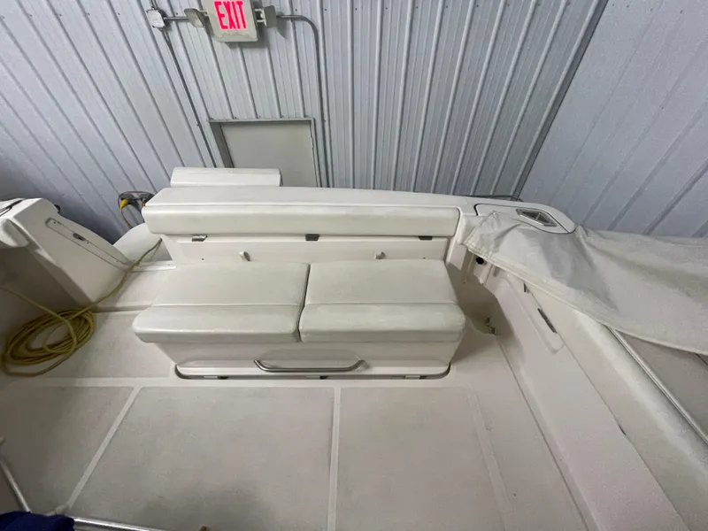 Slide: The Image of 2002 Tiara Yachts 3500 Open interior with white seating and storage compartment. - 5