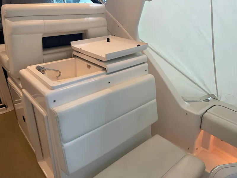 Slide: The Image of 2002 Tiara Yachts 3500 Open interior with white seating and storage compartment. - 7