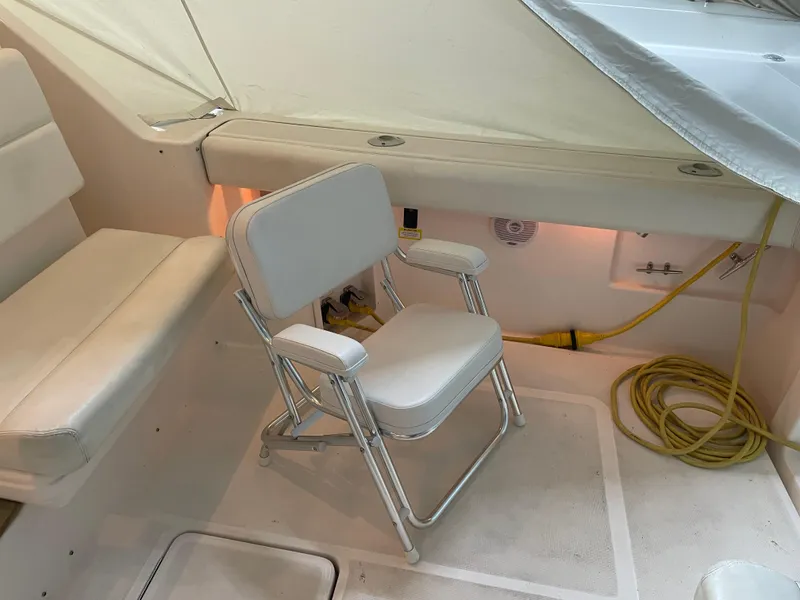 Slide: The Image of 2002 Tiara Yachts 3500 Open interior with white seating and coiled yellow cable. - 8