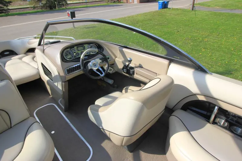 Slide: The Image of 2007 Malibu Wakesetter 23 LSV boat interior with beige seating and dashboard. - 10