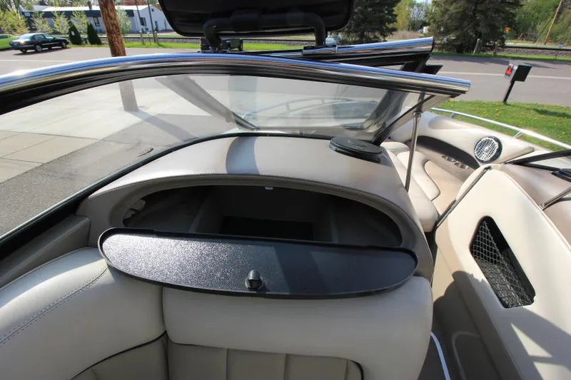 Slide: The Image of 2007 Malibu Wakesetter 23 LSV interior with open glove compartment and sleek design. - 14