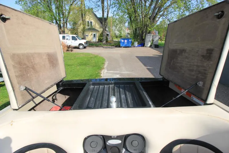 Slide: The Image of 2007 Malibu Wakesetter 23 LSV open storage compartments, outdoor setting. - 15