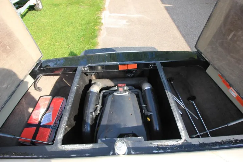 Slide: The Image of 2007 Malibu Wakesetter 23 LSV engine compartment with open hatches and visible components. - 16