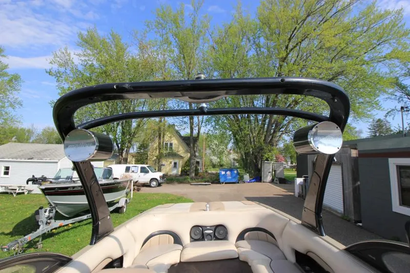 Slide: The Image of 2007 Malibu Wakesetter 23 LSV boat interior with tower speakers, parked outdoors. - 18