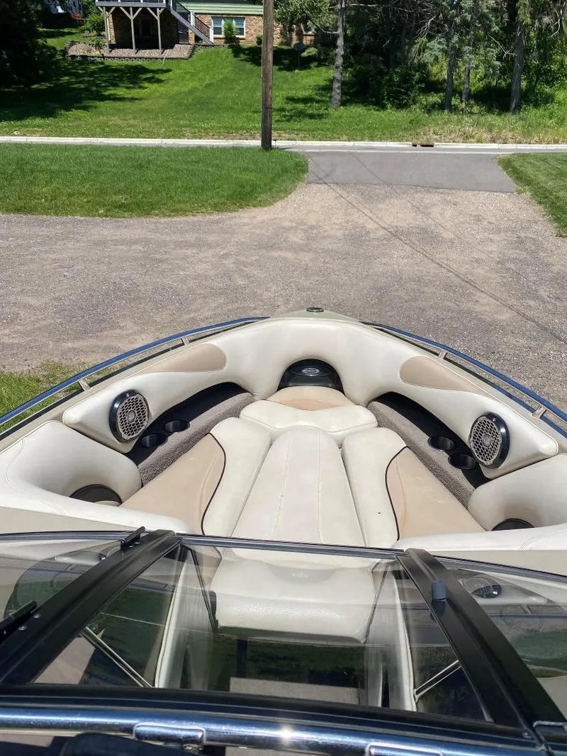 Slide: The Image of 2007 Malibu Wakesetter 23 LSV boat interior with beige seating and speakers. - 7