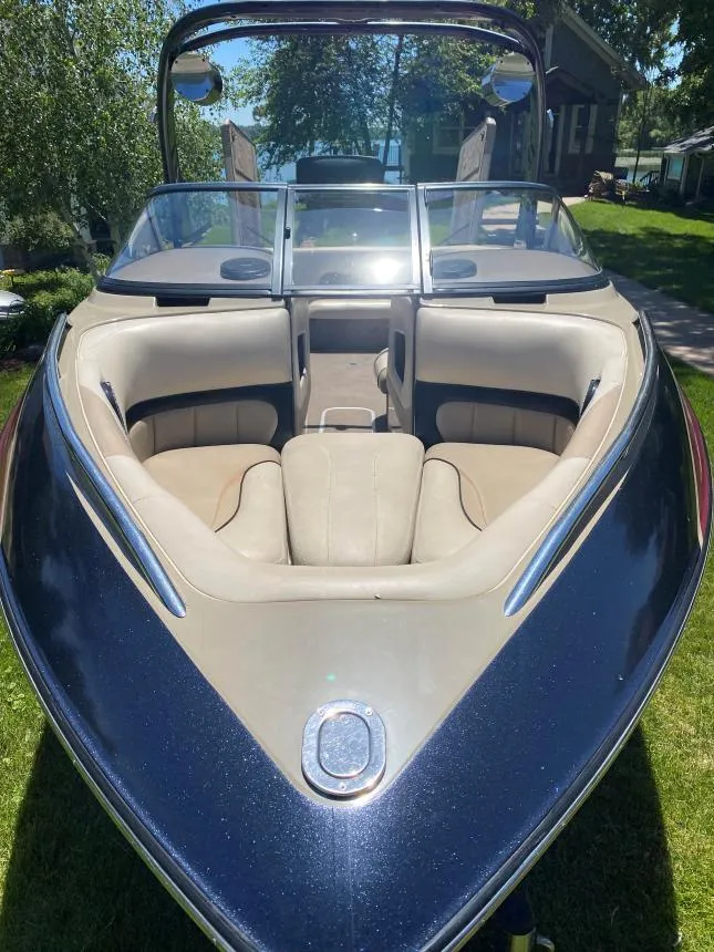 Slide: The Image of 2007 Malibu Wakesetter 23 LSV boat with beige interior, parked on grass. - 9