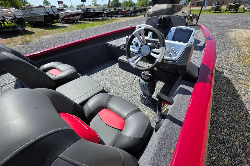Slide: The Image of 2025 Tracker Pro Team 175 TXW Tournament Edition boat interior with steering wheel and seats. - 11