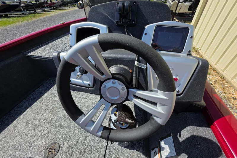 Slide: The Image of Steering wheel of 2025 Tracker Pro Team 175 TXW Tournament Edition boat, featuring dual displays. - 12