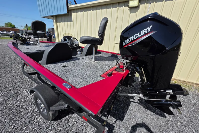 Slide: The Image of 2025 Tracker Pro Team 175 TXW Tournament Edition boat with Mercury engine, parked on gravel. - 8