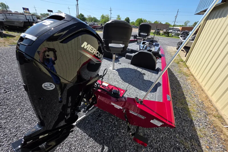 Slide: The Image of 2025 Tracker Pro Team 175 TXW Tournament Edition boat with Mercury engine, parked outdoors. - 9