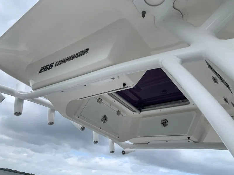 Slide: The Image of 2019 Sea Fox 266 Commander boat roof with storage compartments and overcast sky. - 12