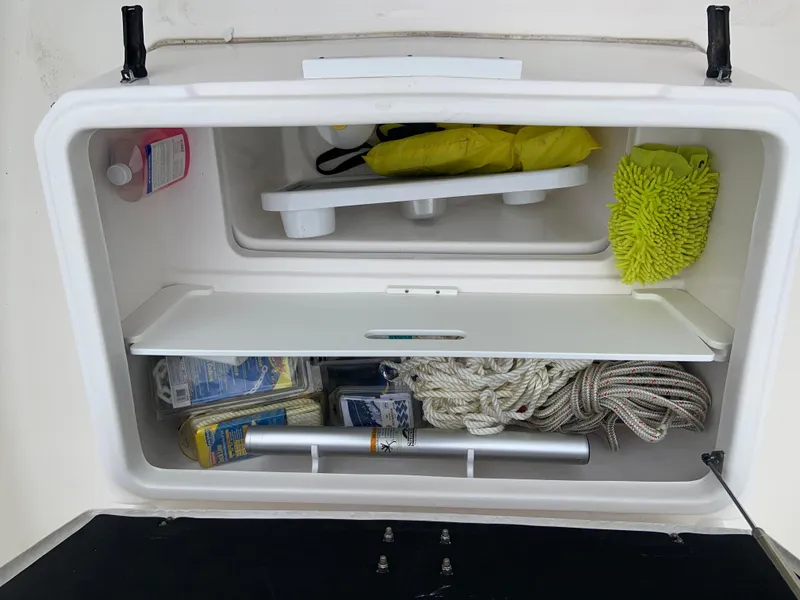 Slide: The Image of Storage compartment of 2019 Sea Fox 266 Commander boat with ropes and cleaning supplies. - 16
