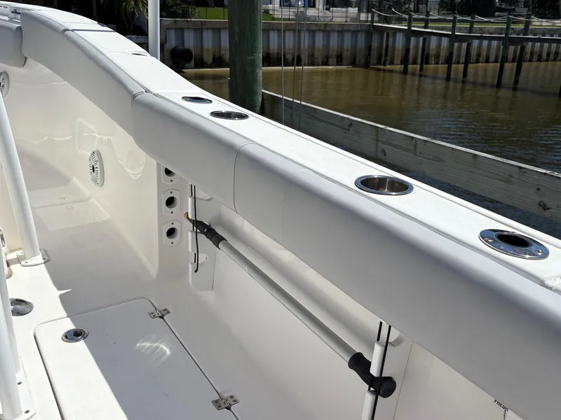 Slide: The Image of 2019 Sea Fox 266 Commander boat interior with rod holders and clean white deck. - 24