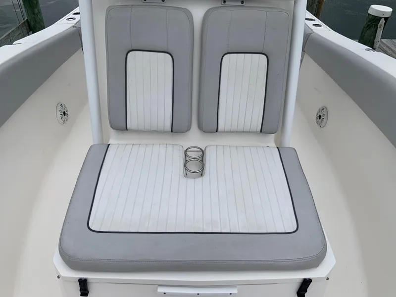 Slide: The Image of 2019 Sea Fox 266 Commander boat seating with cup holders, featuring gray and white upholstery. - 9