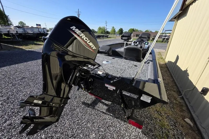 Slide: The Image of 2025 Tracker Pro Team 175 Crappie Edition boat with Mercury engine, parked on gravel. - 5