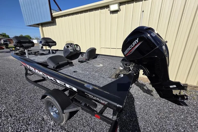 Slide: The Image of 2025 Tracker Pro Team 175 Crappie Edition boat interior with steering wheel and seating. - 6