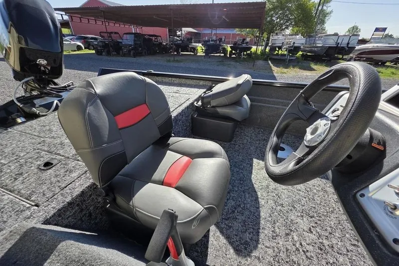 Slide: The Image of 2025 Tracker Pro Team 175 Crappie Edition boat interior with seating and steering wheel. - 7