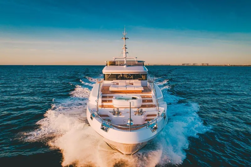 Slide: The Image of Luxurious 2020 Benetti Delfino yacht cruising on open sea at sunset. - 3
