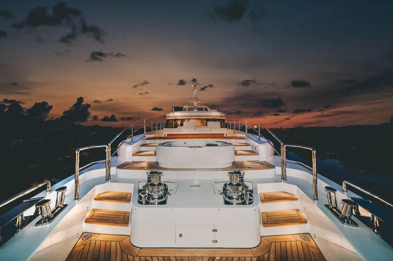 Slide: The Image of Luxurious 2020 Benetti Delfino yacht deck at sunset, featuring elegant wooden finishes. - 8