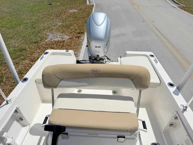 Slide: The Image of 2016 Key West 1720 Center Console boat with beige seating and outboard motor. - 13