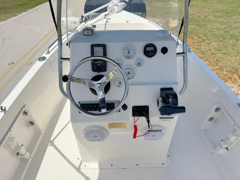 Slide: The Image of 2016 Key West 1720 Center Console boat dashboard with steering wheel and control panel. - 15
