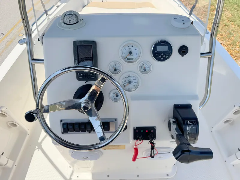 Slide: The Image of 2016 Key West 1720 Center Console boat dashboard with steering wheel and controls. - 16