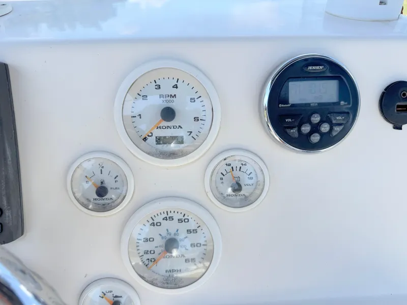 Slide: The Image of Dashboard of a 2016 Key West 1720 Center Console boat with Honda gauges and Jensen audio system. - 17