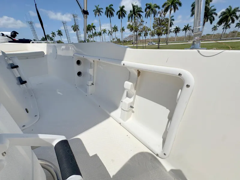 Slide: The Image of 2016 Key West 1720 Center Console boat interior with palm trees in the background. - 21