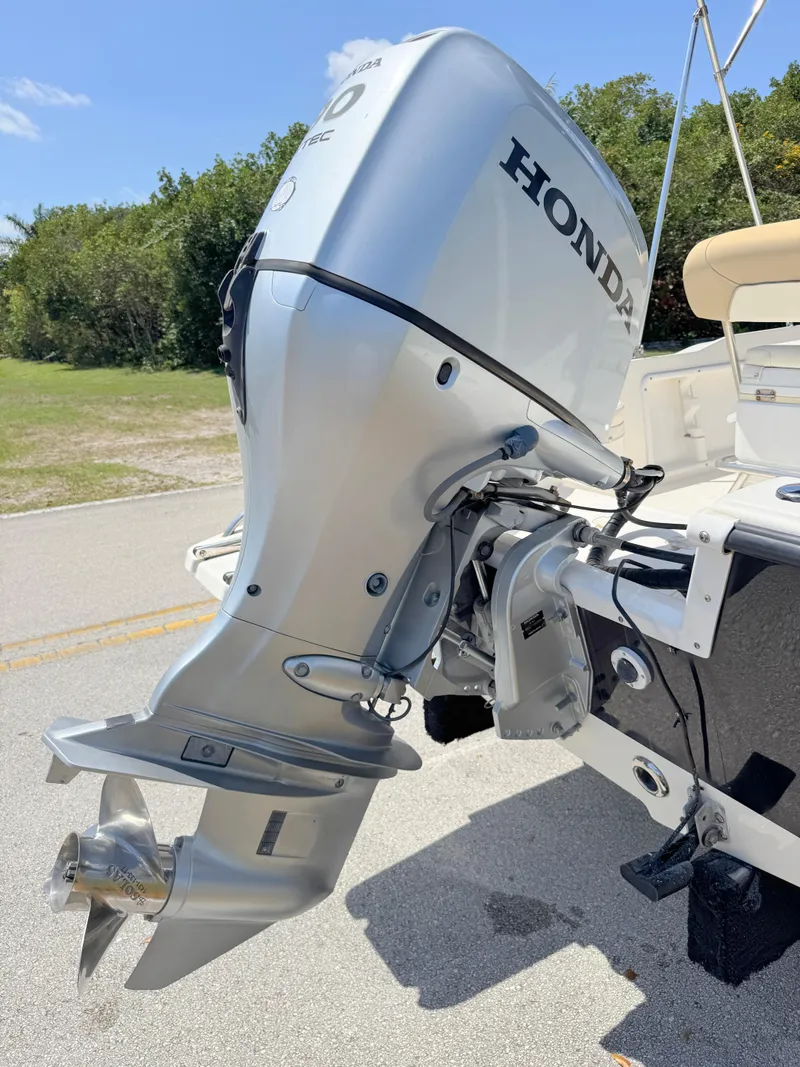 Slide: The Image of 2016 Key West 1720 Center Console with Honda outboard motor, parked on a sunny day. - 27