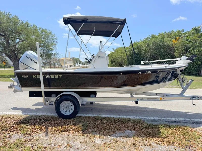 Slide: The Image of 2016 Key West 1720 Center Console boat on trailer, parked outdoors. - 5