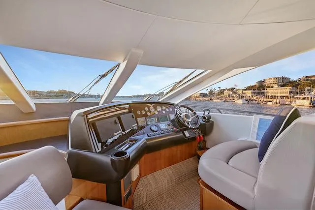 Slide: The Image of Helm of 2008 Sunseeker Manhattan 60 yacht with modern controls and coastal view. - 17